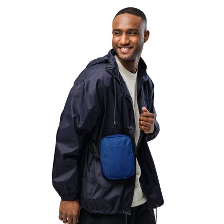 Denim crossbody bag worn across the chest by a smiling model