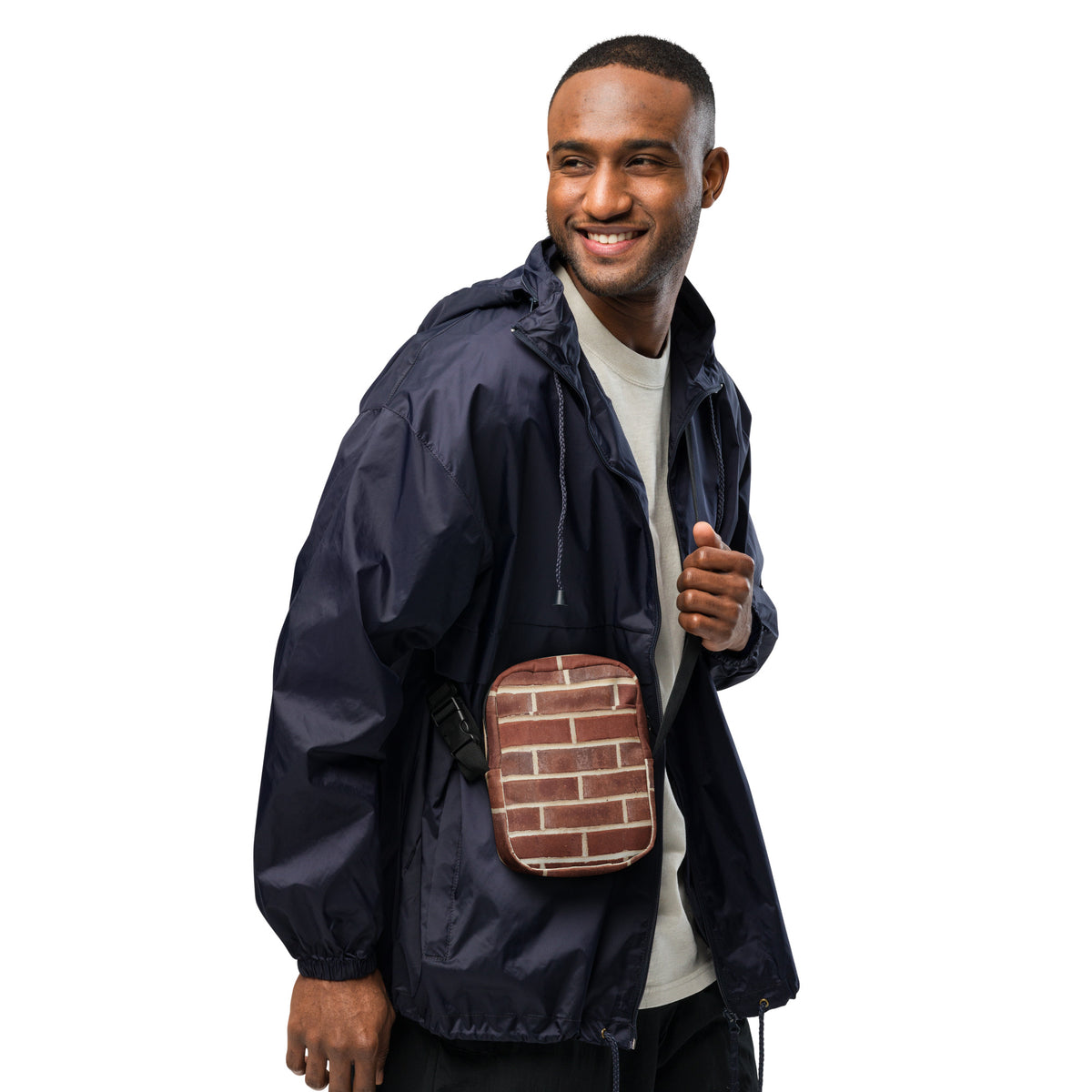 Brick crossbody bag worn across the chest by a smiling model