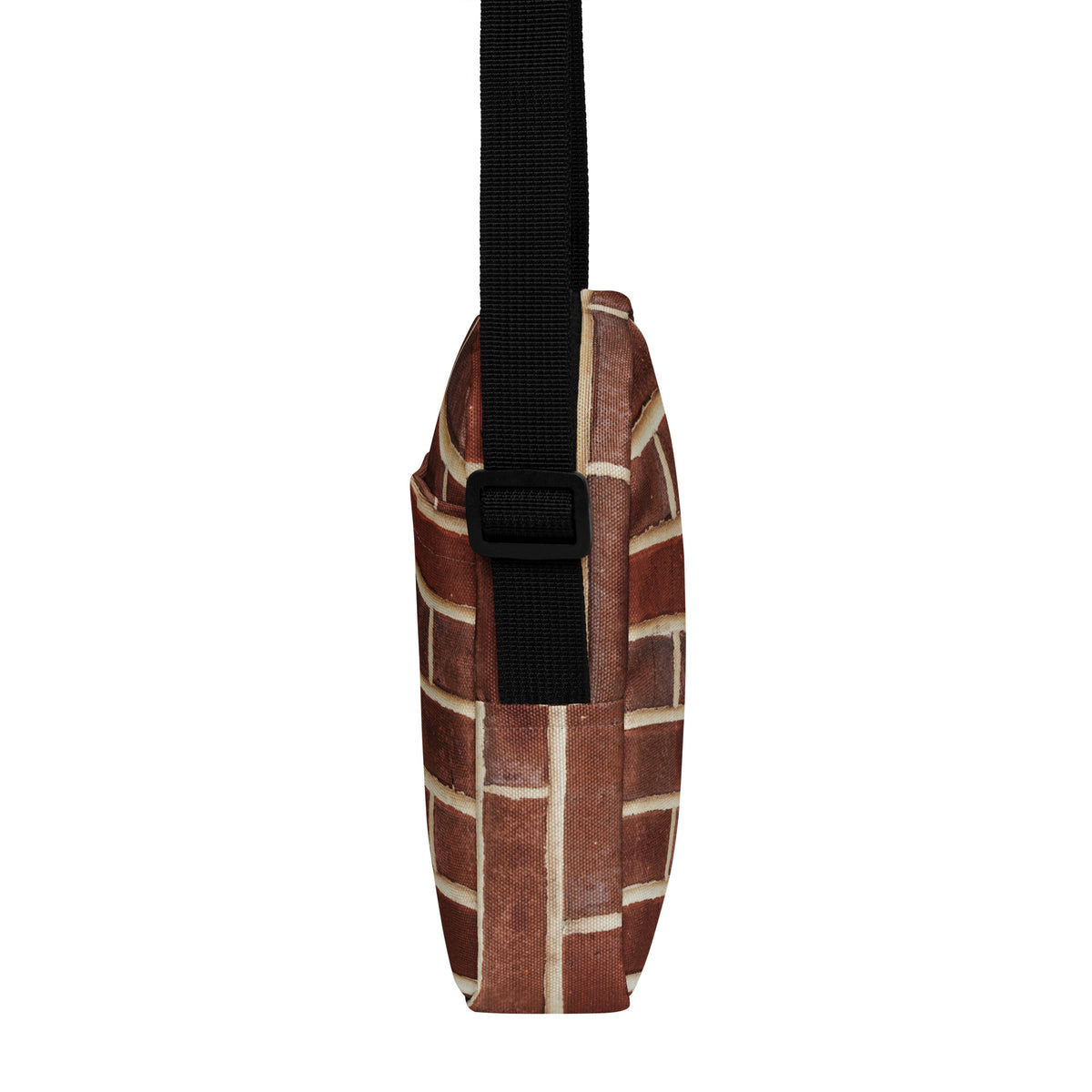 Brick crossbody bag, side profile showing the two-inch depth and strap buckle