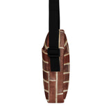 Brick crossbody bag, side profile showing the two-inch depth and strap buckle