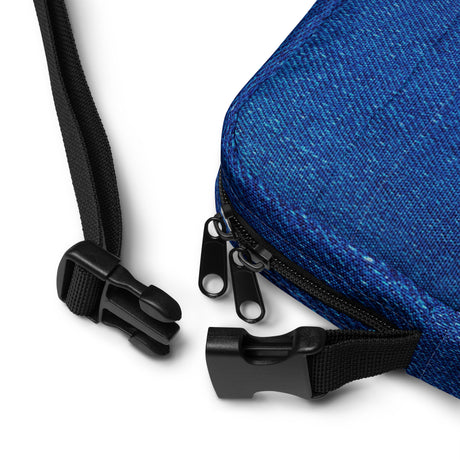 Close-up of the Denim crossbody bag strap clasp and adjustable webbing