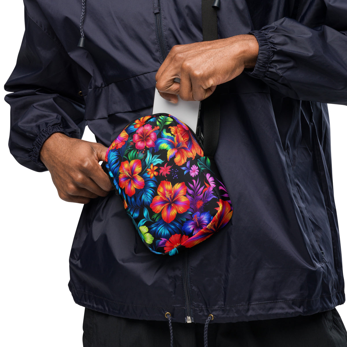 Neon Floral crossbody bag worn at the hip, phone being slipped into the front pocket
